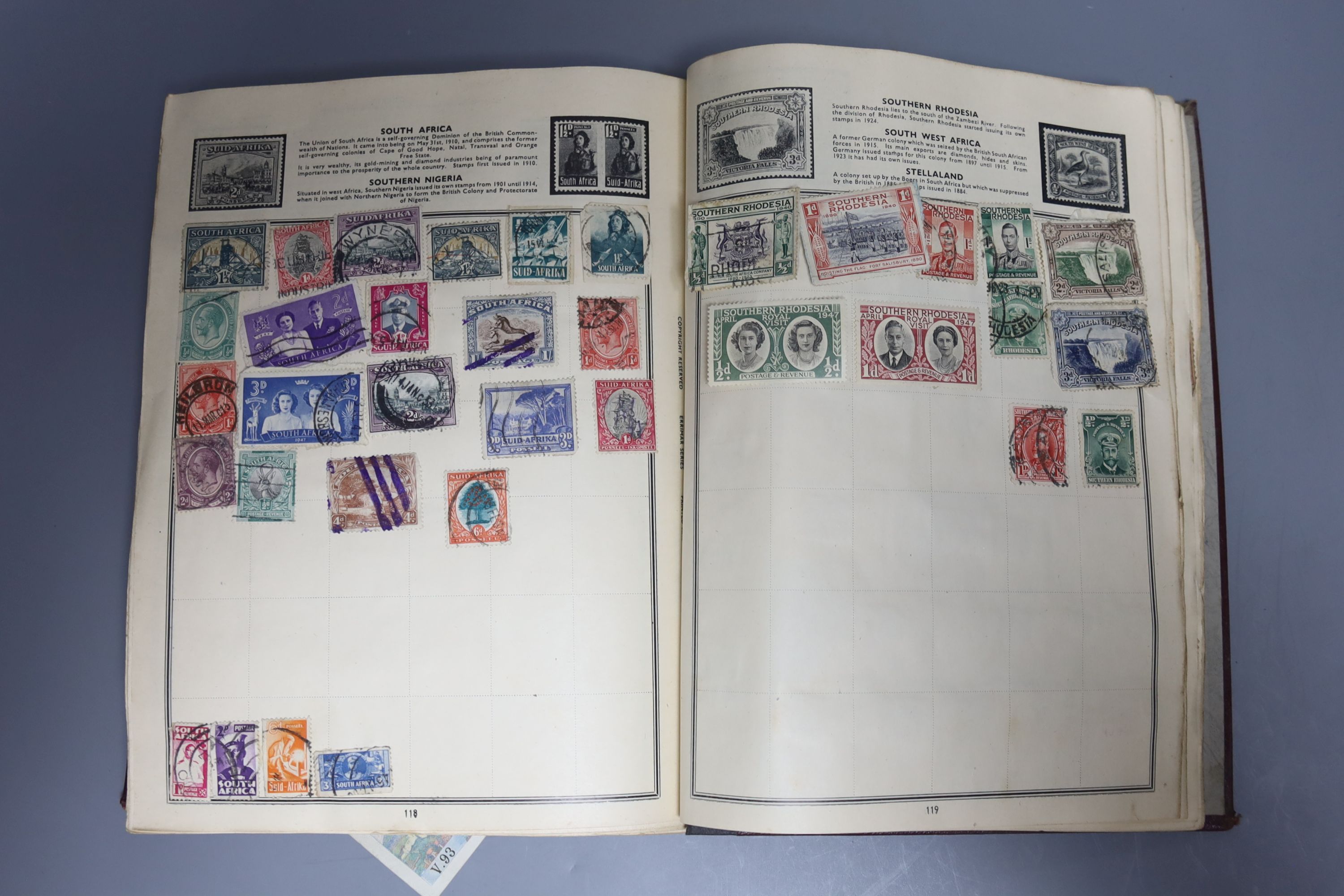 A Pacific stamp album with mixed world stamps, together with two pairs of brass candlesticks (5)